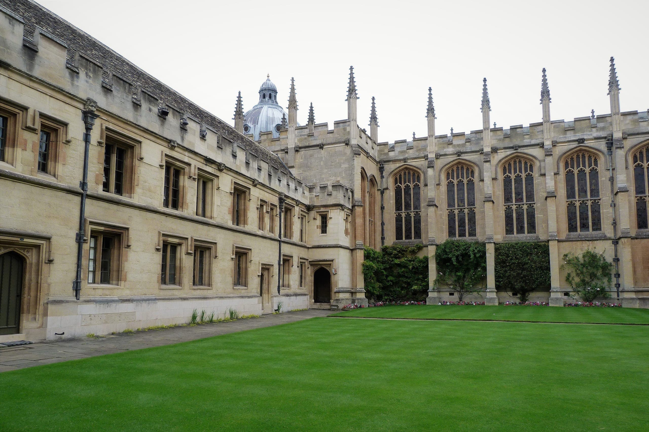Stone college quadrangle viewed through an archway