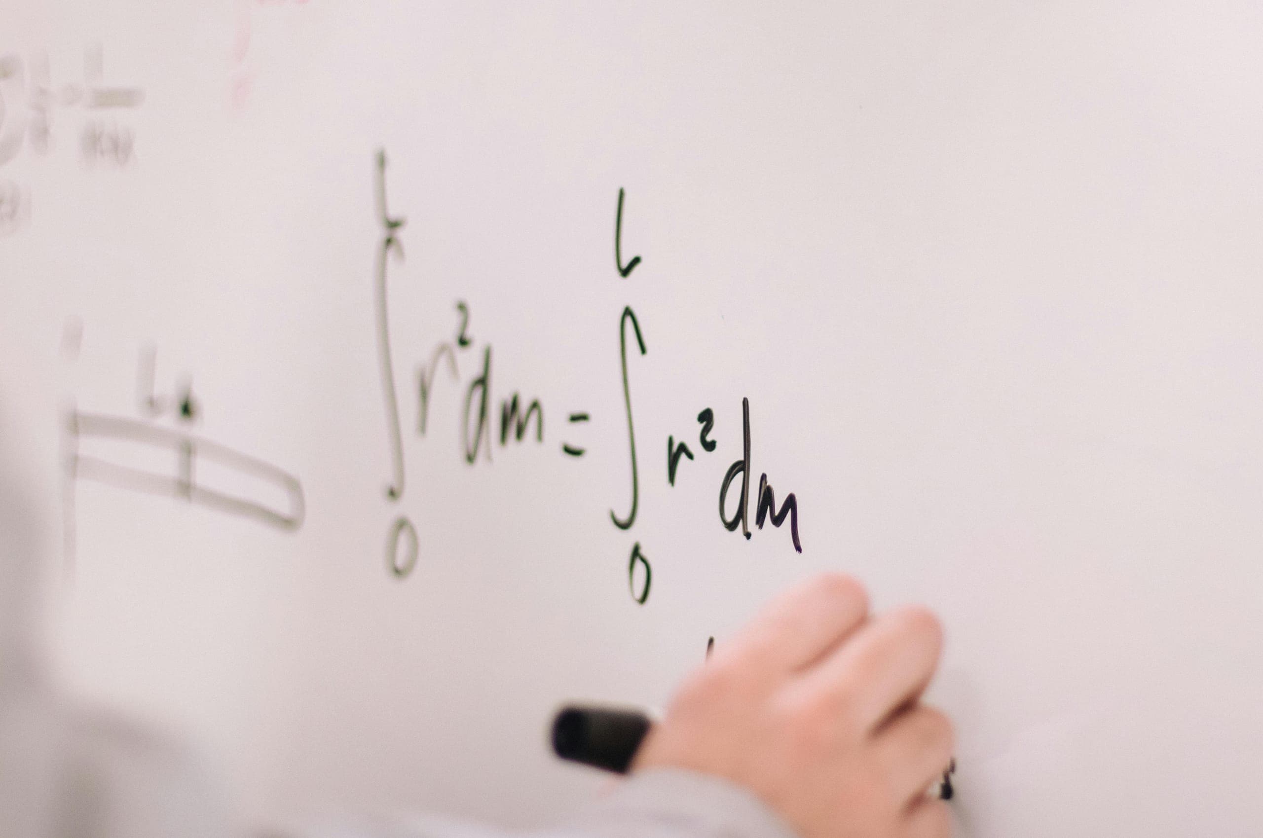 Mathematics worked through on a whiteboard during a lecture